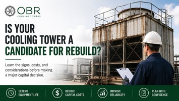 Facility technician inspecting an aging cooling tower to evaluate whether the system is a candidate for repair or rebuild instead of replacement.